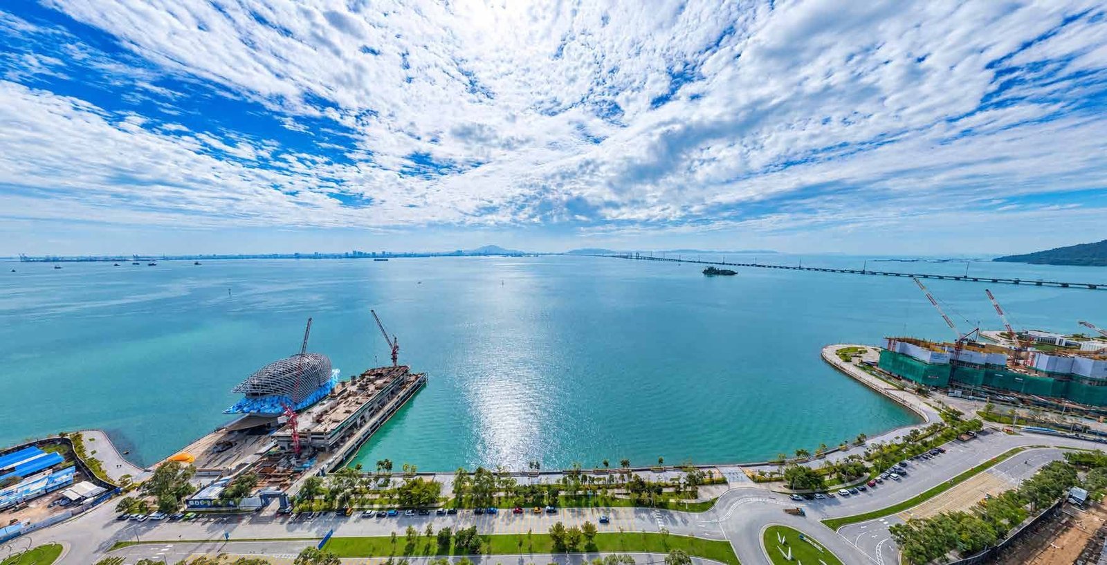 Aerial photograph over the sea from the site, with the Penang Bridge on the horizon